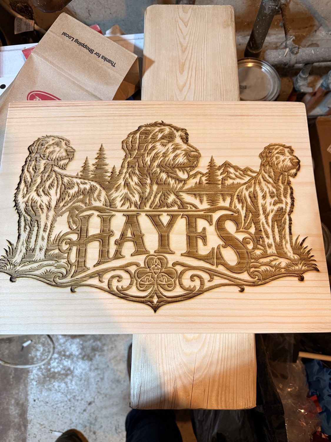Hayes family wooden sign featuring three dogs and mountain scenery