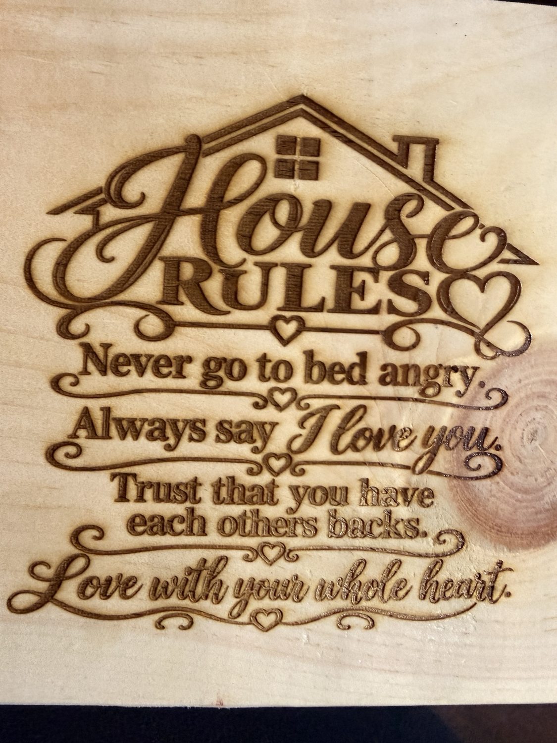 Wooden House Rules sign with family sayings and decorative hearts