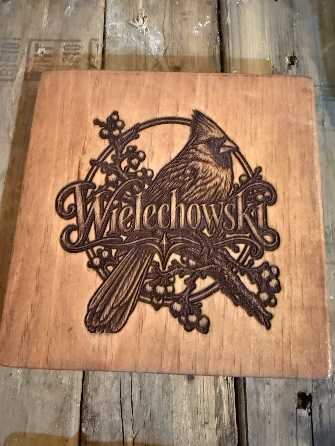 Wooden Wielechowski family name sign featuring a cardinal and decorative branches